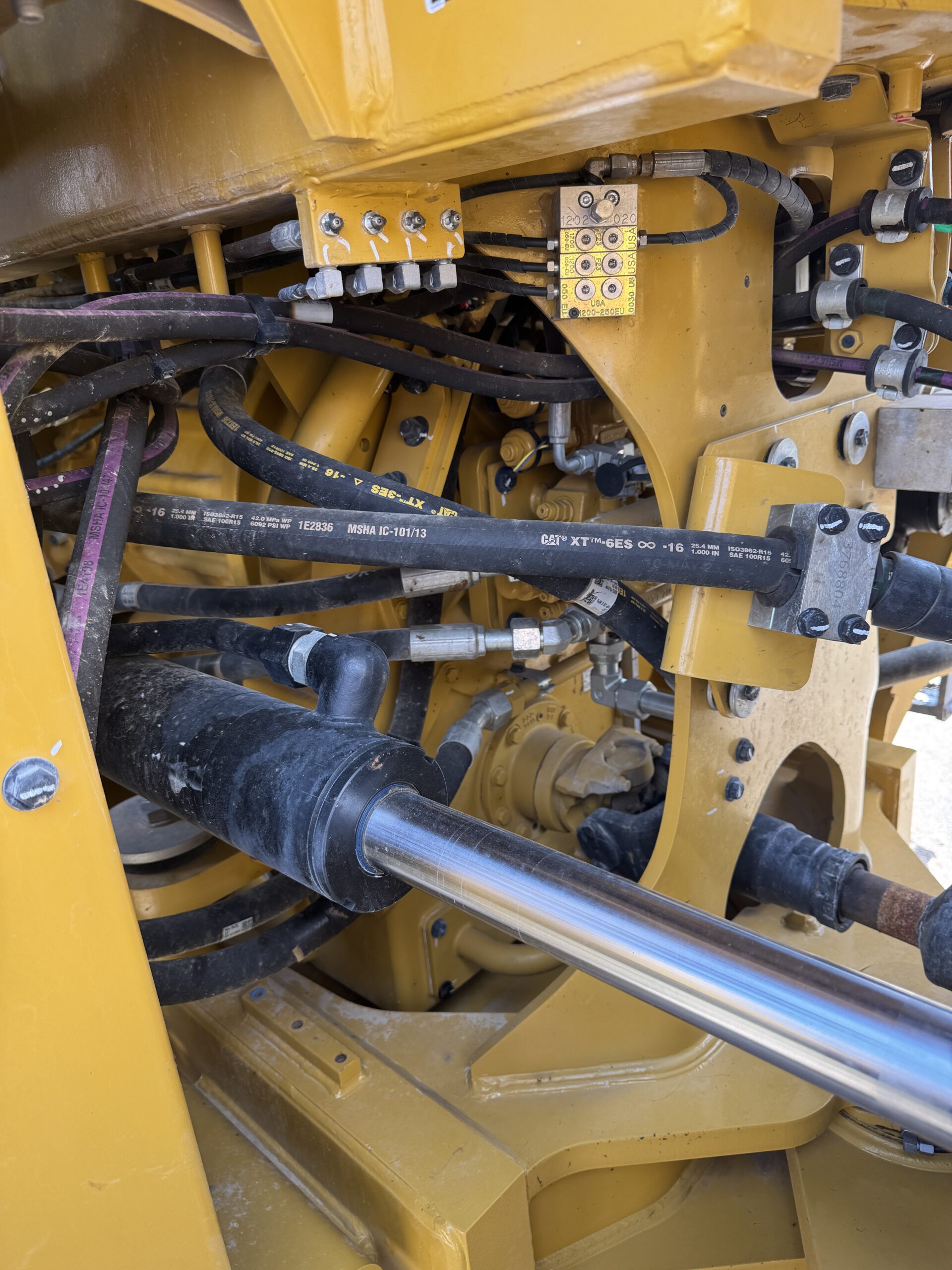 Up close mechanical view of late model Cat 966KM with only 790 hours for sale.