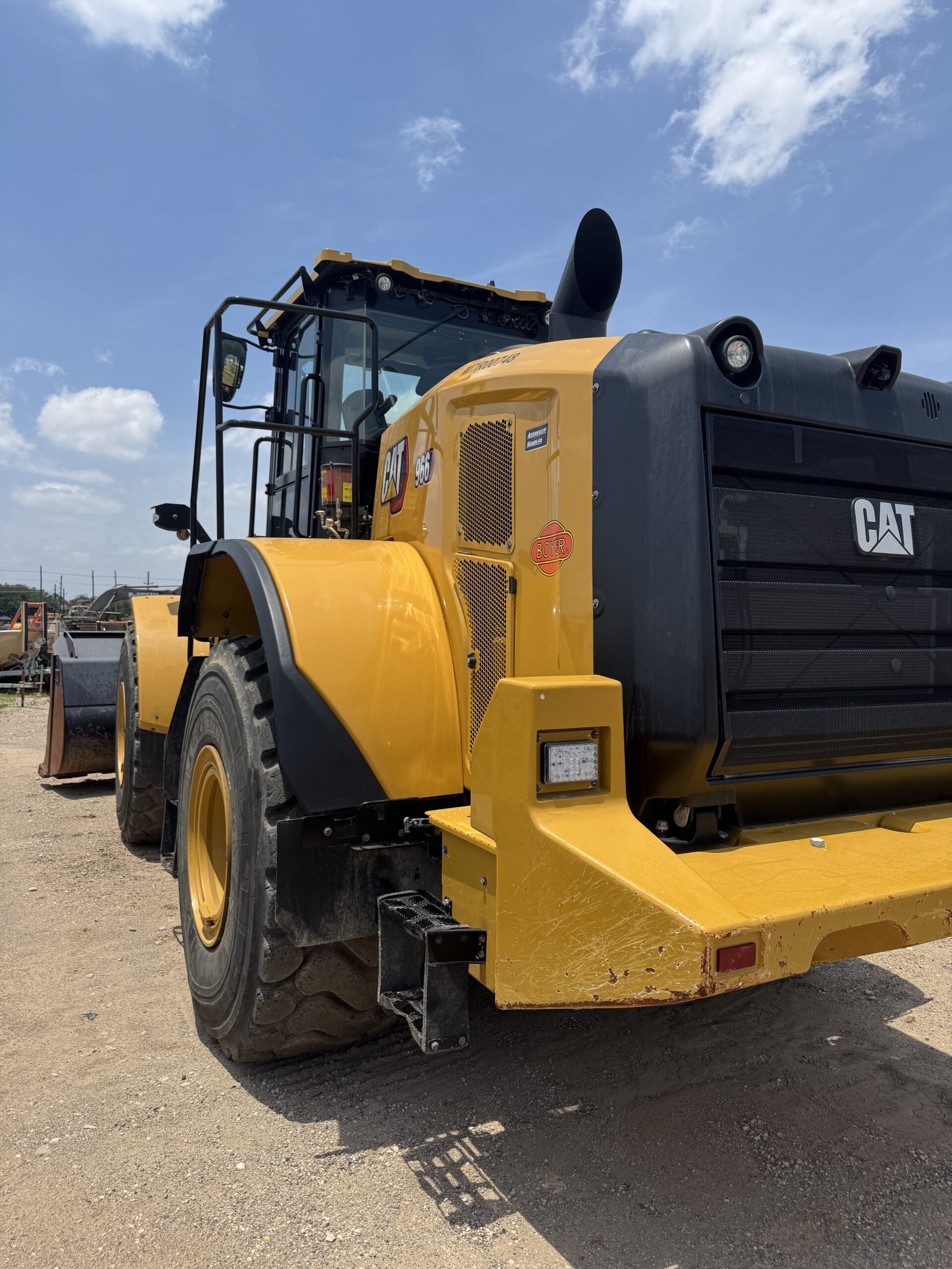 Premium 966KM Cat wheel loader with quick coupler system, side rear left view.