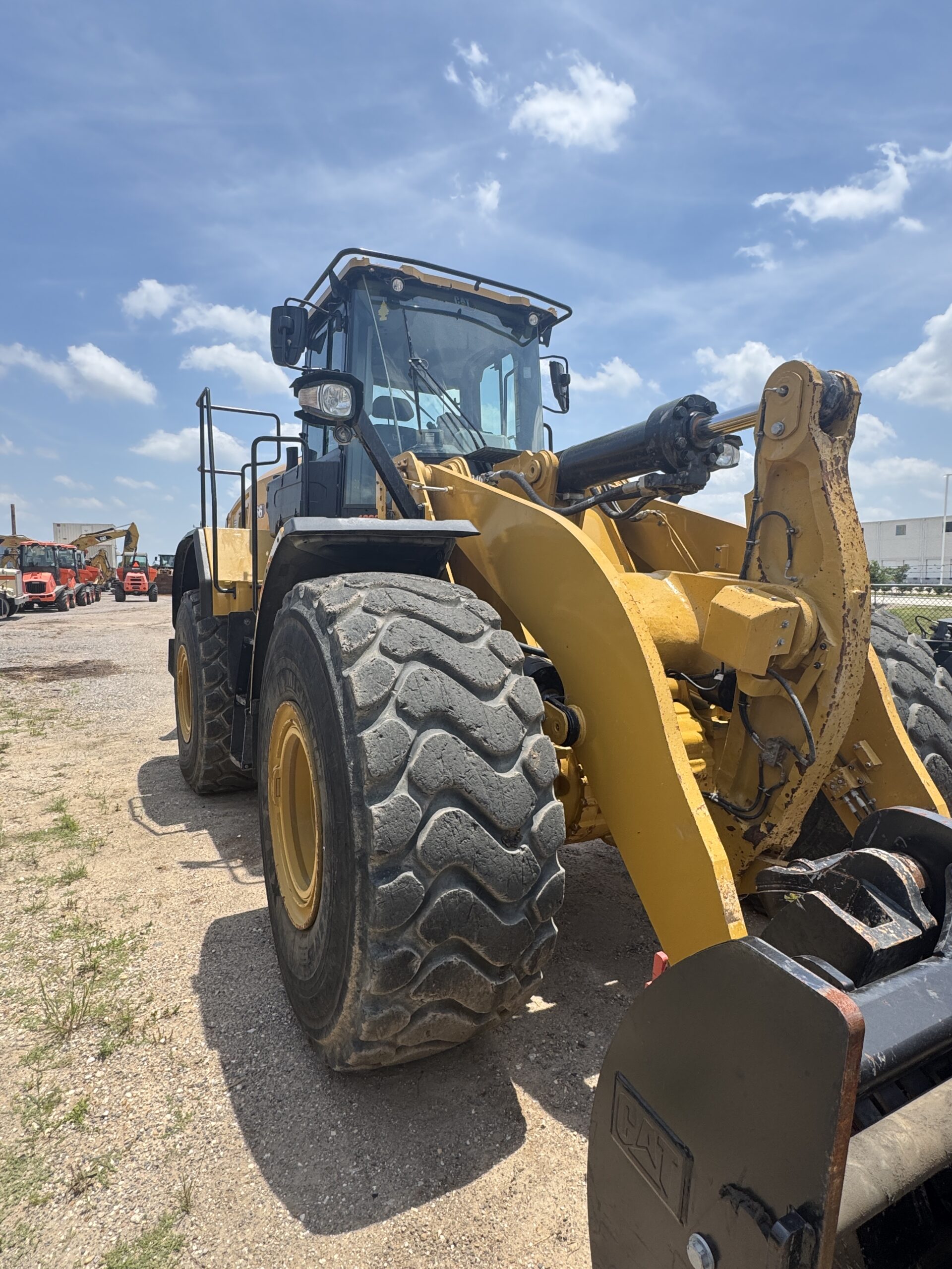 Premium 966KM Cat wheel loader with quick coupler system, side front left view.