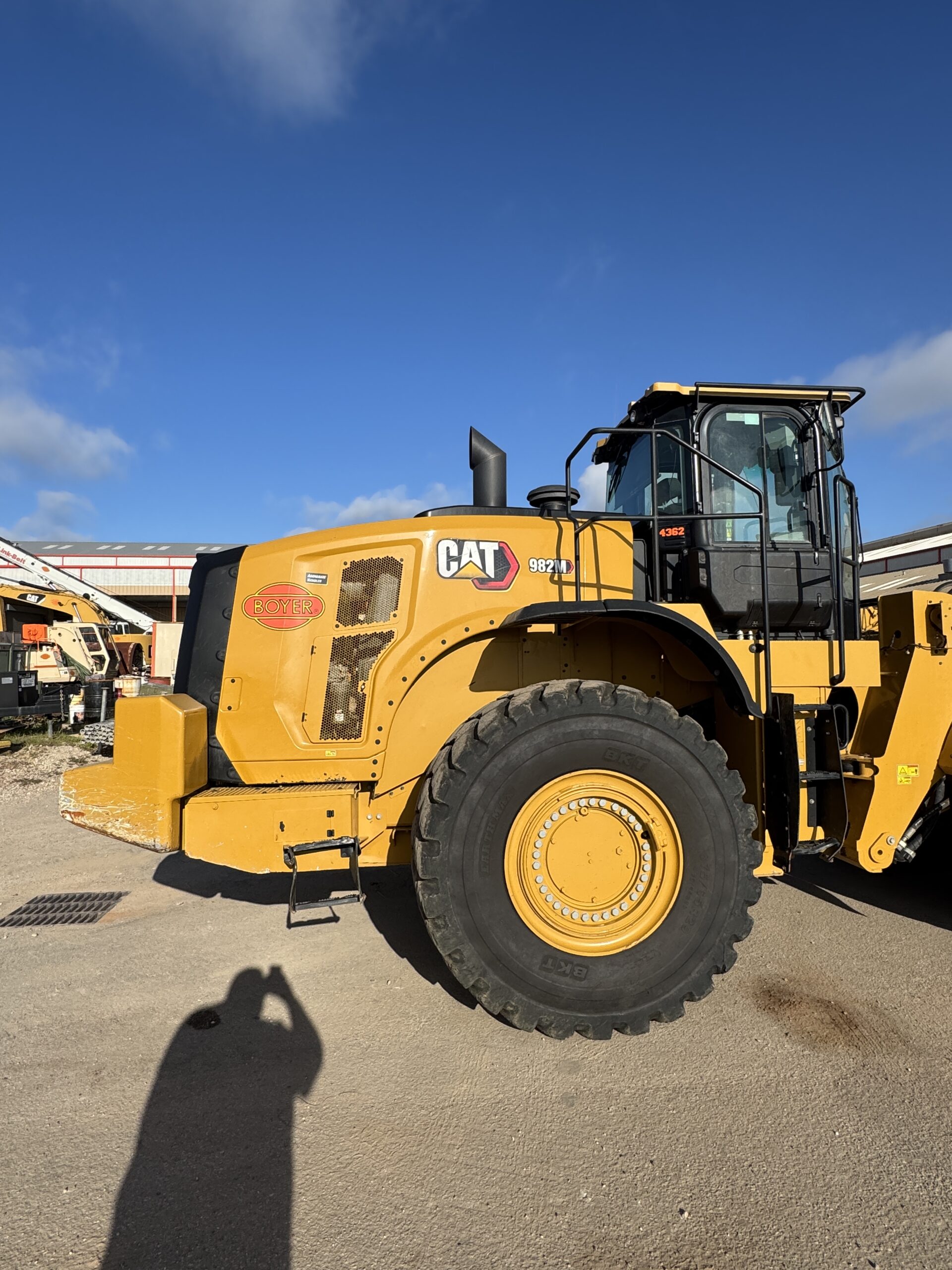 Right side profile 1 of 982M loader showing large tire and robust frame