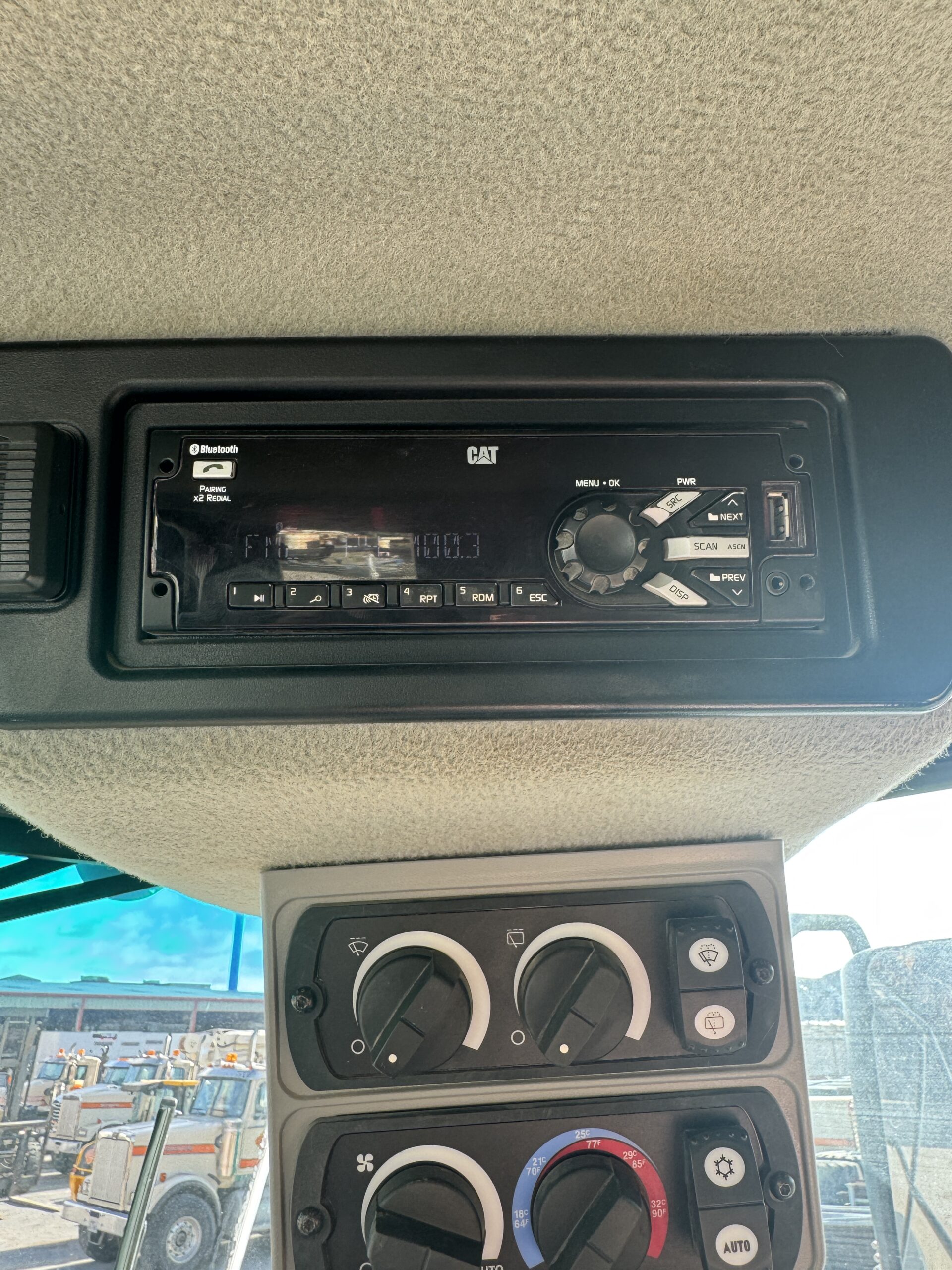 Operator cab interior view 1 of Cat 982M with modern controls and HVAC
