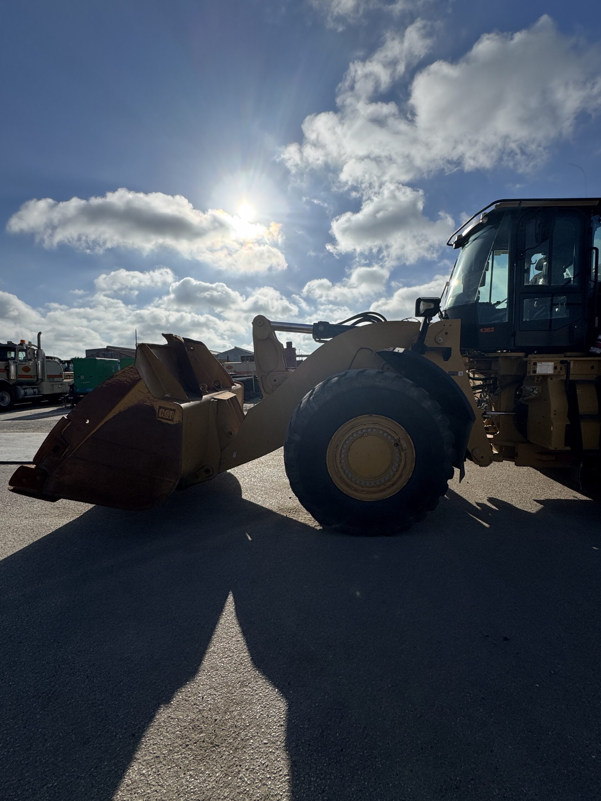 Side profile 1 of 982M loader showing large tire and robust frame