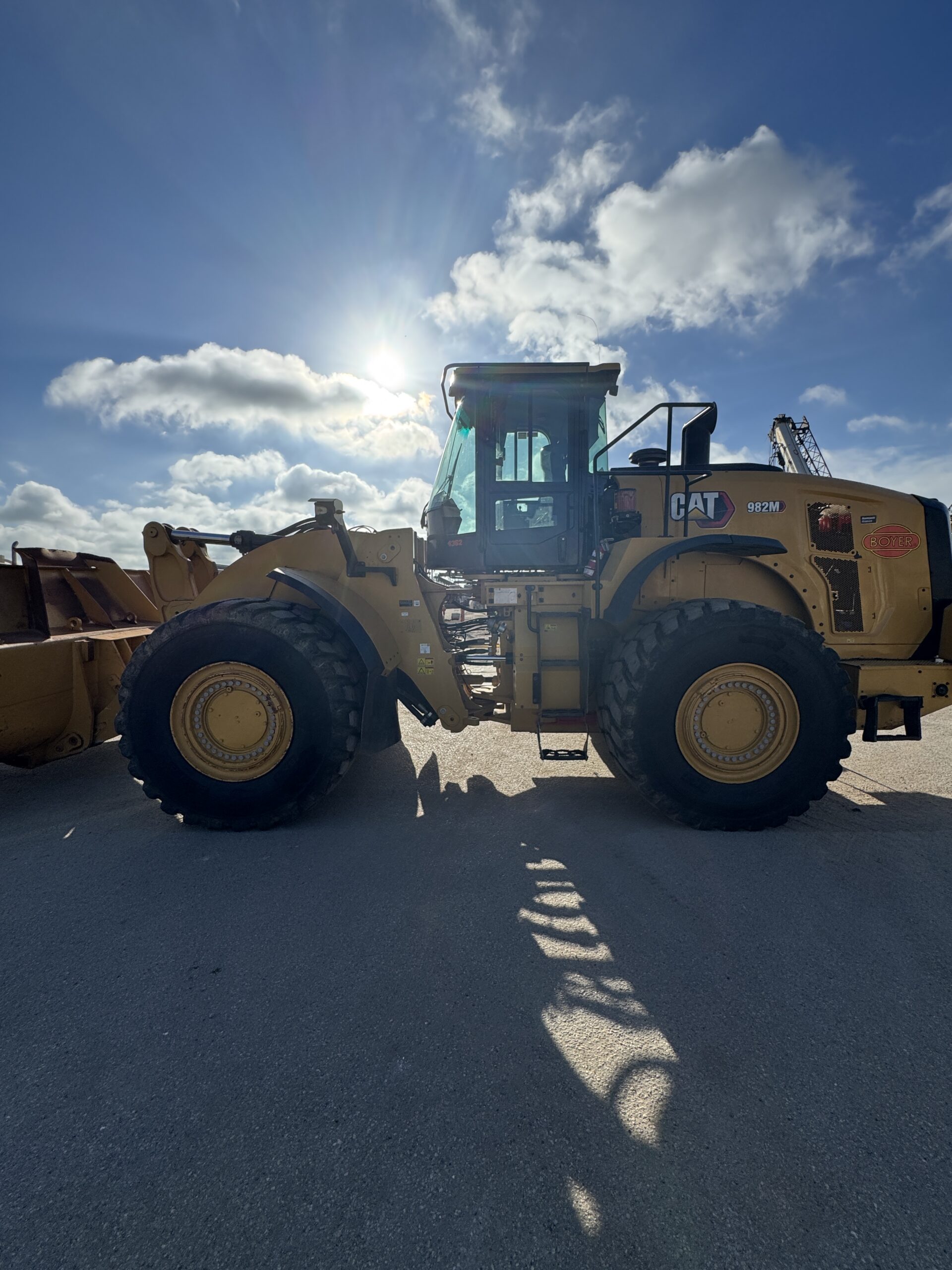 Side profile 2 of 982M loader showing large tire and robust frame
