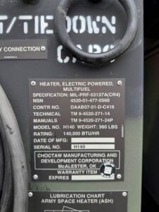 Identification nameplate for military surplus portable duct type heater showing NSN 4520-01-477-0568, Model H140, 140,000 BTU/HR rating, and Choctaw Manufacturing credentials.